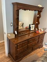 Front view of dresser with mounted hutch mirror and shelves