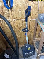 Snow Joe corded electric snow shovel full view leaning against wall