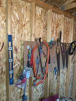 Wall section with pegboard displaying assortment of hand tools