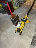 Both jacks together: yellow floor jack and red bottle jack