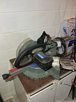 Full view of King Canada sliding compound miter saw on cabinet