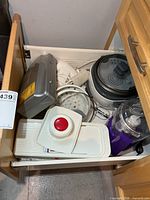 Drawer containing rice cooker, mandoline slicer, food processor, mixer, carving set case