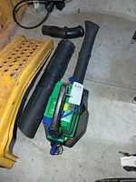Overhead view of WeedEater Barracuda blower with two straight tubes and curved elbow tube