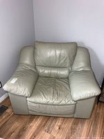 Front view of oversized leather armchair showing overall design