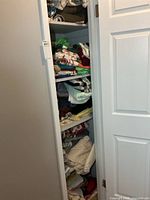 Full closet view showing shelves stacked with assorted linens