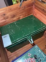 Closed green box showing exterior wear and latch