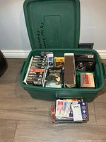 Green tote with assorted VHS and DVD movies