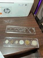 Six coins displayed in plastic holder, overview of lot