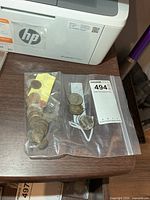 Two plastic bags containing assorted coins including Kennedy half dollars and mixed smaller coins