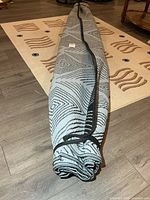 Rolled outdoor mat showing full length with tie straps