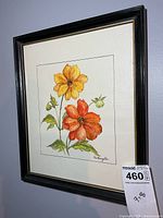 Framed floral watercolor on wall with auction tag visible
