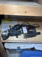 Craftsman jigsaw and angle grinder on shelf