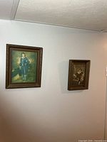 Two framed prints on wall: color boy in blue, sepia child