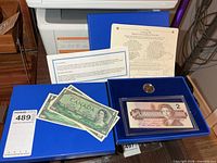 Full set displayed with box, certificate, coin, $2 note, four $1 notes