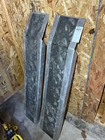 Both aluminum ramps leaning against wall