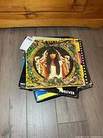 Stack of vinyl LPs topped by female-artist ornate frame cover