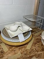 stack showing condiment dishes, platters, metal rack