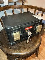 Front angled view of Honeywell safe showing badge, latches and keys inserted
