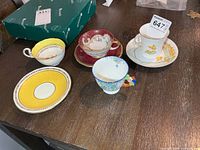 Group shot of four teacups and three saucers on tabletop