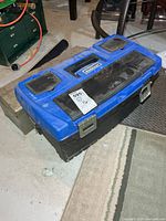 Blue and black Mastercraft plastic toolbox closed; lot sticker visible