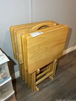 five folded TV tables and stand front view