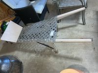 Top view of wooden cart with plastic lattice surface and handles