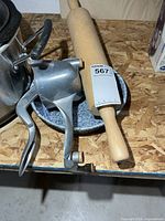 Rolling pin, juicer, enamel pan grouped together on table