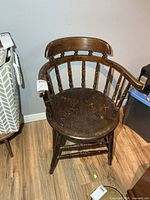 Front view of wooden pub chair showing overall design and wear