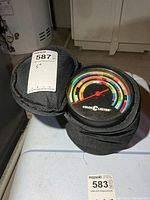 Color C-Lector device in open zip case showing dial