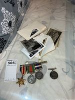 Overall lot showing medals, ribbons, photo envelopes and prints