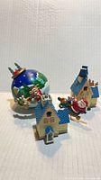 Group showing blue rotating ornament and two plastic houses