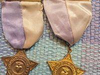 Two medals showing ribbons and star form