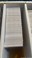 Top view of densely packed stack of cards inside long storage box