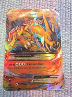 Front view of Mega Charizard EX card showing full foil artwork and text