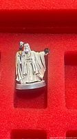 Front view of unpainted Gandalf metal miniature on red foam tray