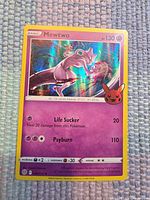 Front of Mewtwo card showing holo artwork, attacks and HP