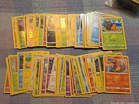 Two rows of stacked Pokémon cards showing variety of commons and uncommons