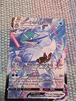 Front view of Ice Rider Calyrex VMAX card displaying artwork, HP, attacks and set number
