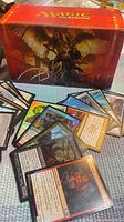 assorted MTG cards fanned out in front of red box