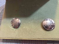 Two round sterling silver earrings in box