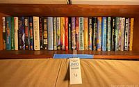 Row of Anne McCaffrey novels on shelf showing spines