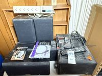 Group shot of receiver, speakers, surge protector, packaged cables, remote