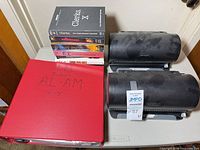 Overall lot showing two disc organizers, red binder, stack of DVD box sets