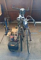 Front view of both bicycles, pumps, packaged accessories and tool bag