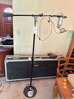 Full view of microphone mounted on floor stand with boom arm