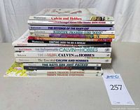 Stacked spines of 13 Calvin and Hobbes softcover books showing titles