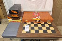 Group view of chessboard, backgammon cases, domino sets, vinyl board, Hoyle book