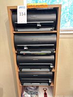 Wooden shelf with four Atlantic Disc Manager organizers and binder below