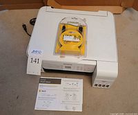 Top view of Epson ET-2720 printer with USB cable package and Start Here guide