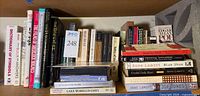 Shelf with assorted reference and fiction books plus audio media